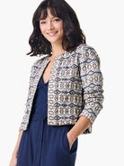 Cream jacket with navy, gold, and beige geometric pattern.  Short sleeves, cropped length.
