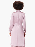 Lilac satin trench coat, long sleeves, cinched waist, and a slight ruffle at the hem.