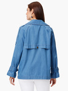 Light blue denim trench coat,  long sleeves with belted cuffs, collared.  Back view.