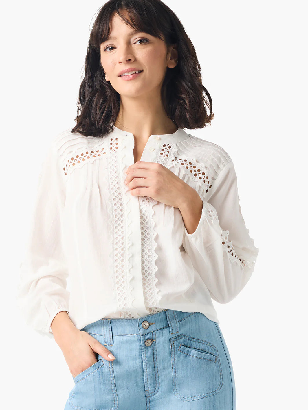 Off-white blouse with white eyelet embroidery along the front placket and sleeves.  Long sleeves, button front.
