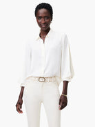 Off-white satin chiffon shirt; long sleeves with slight puff at shoulder; button-front closure.
