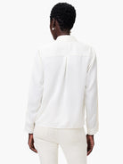 Off-white satin chiffon shirt; long sleeves, collared, back view.