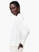 Off-white satin chiffon shirt; long sleeves, collared, button front.