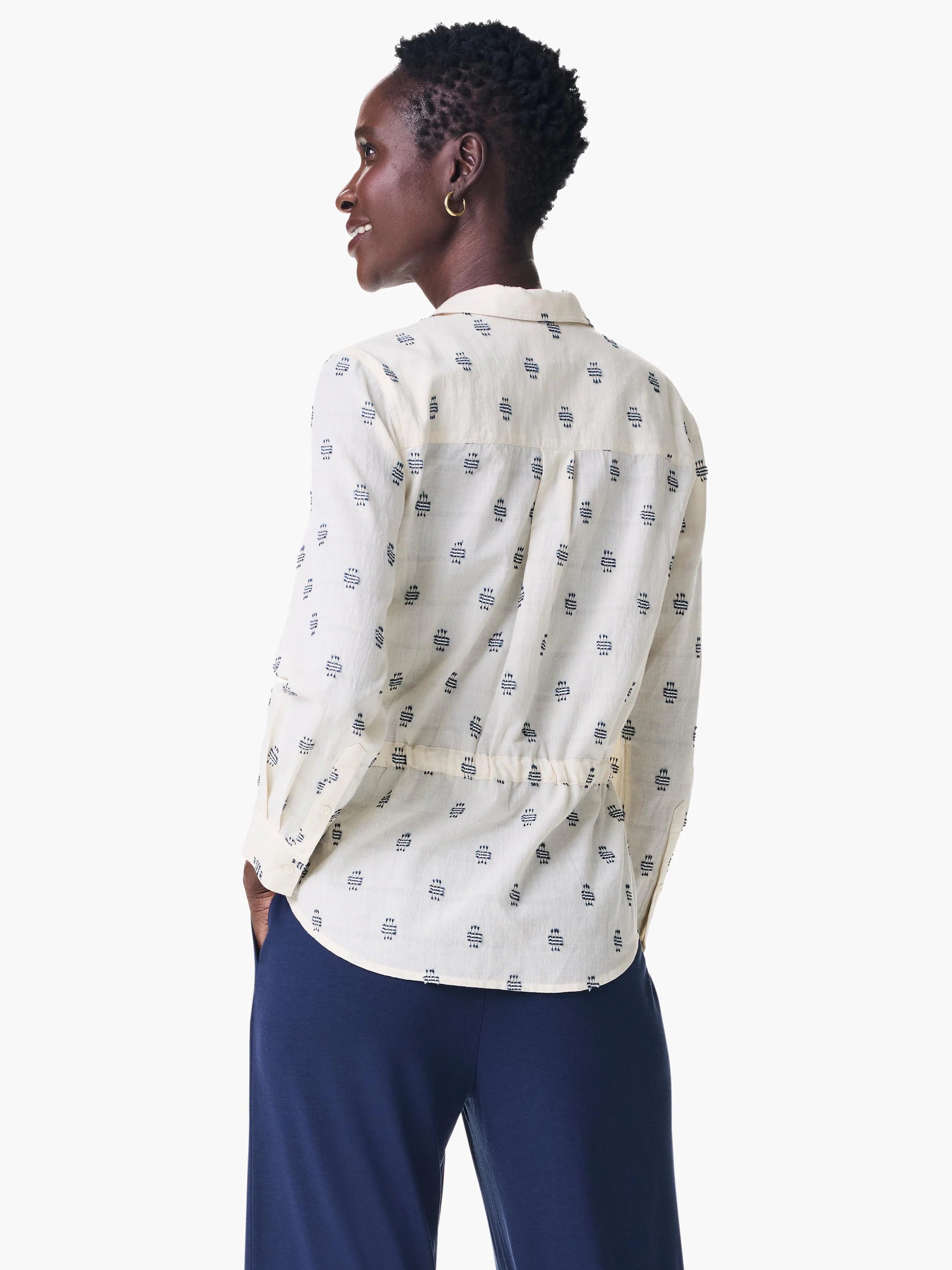 Cream shirt jacket with navy blue geometric pattern, long sleeves, and cinched waist.