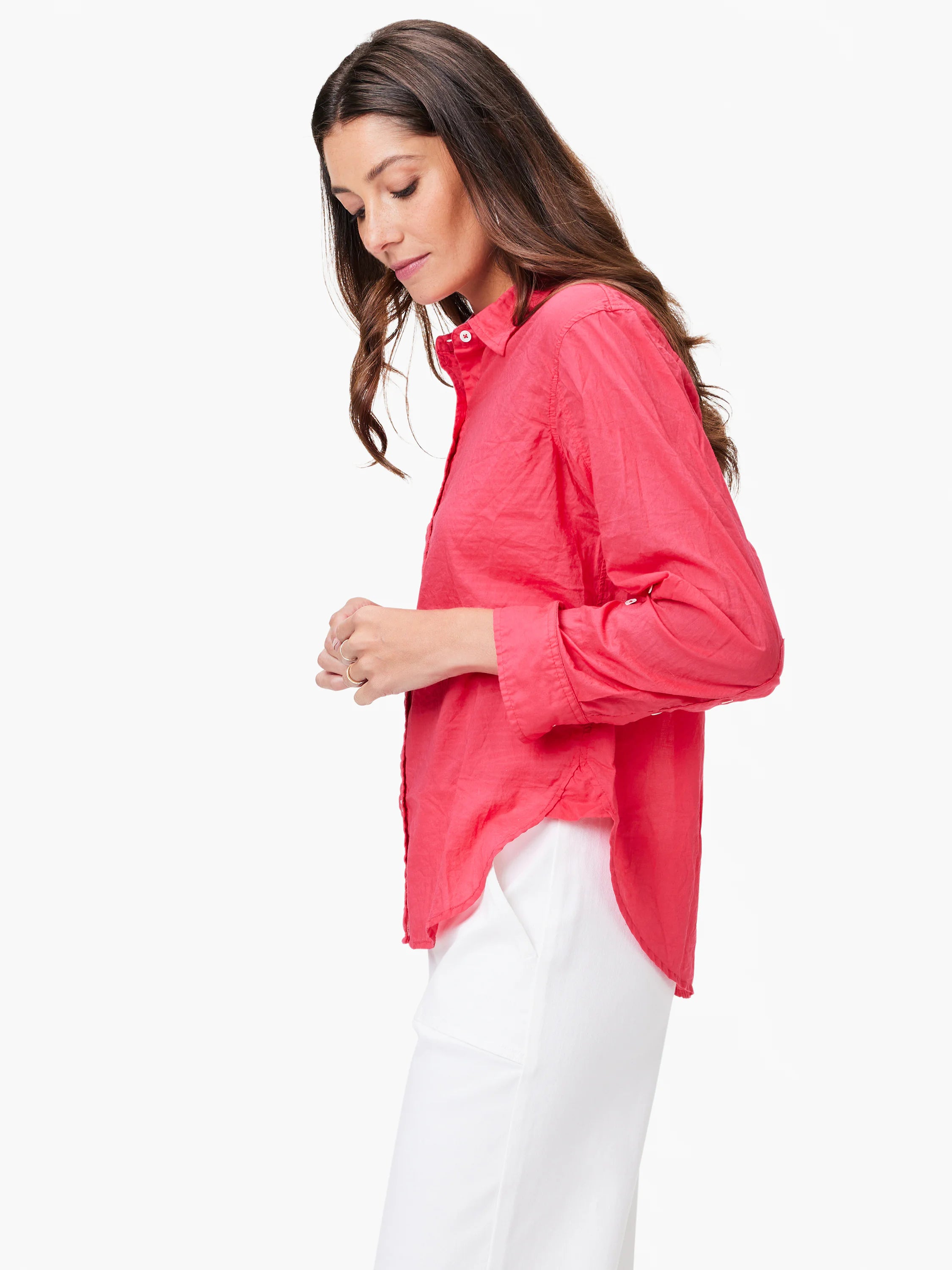 Coral button-up shirt with a crinkled texture, white buttons, a collar, cuffed long sleeves, and a rounded high-low hem.