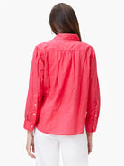 Back view: Coral, relaxed-fit cotton shirt with crinkled texture, pleated back yoke, and white buttons on sleeves.