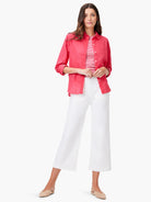 Coral, relaxed-fit button-up shirt with rolled long sleeves and a subtly crinkled texture.