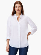 White cotton collared shirt with button-down front, long sleeves rolled up and secured. Relaxed fit.