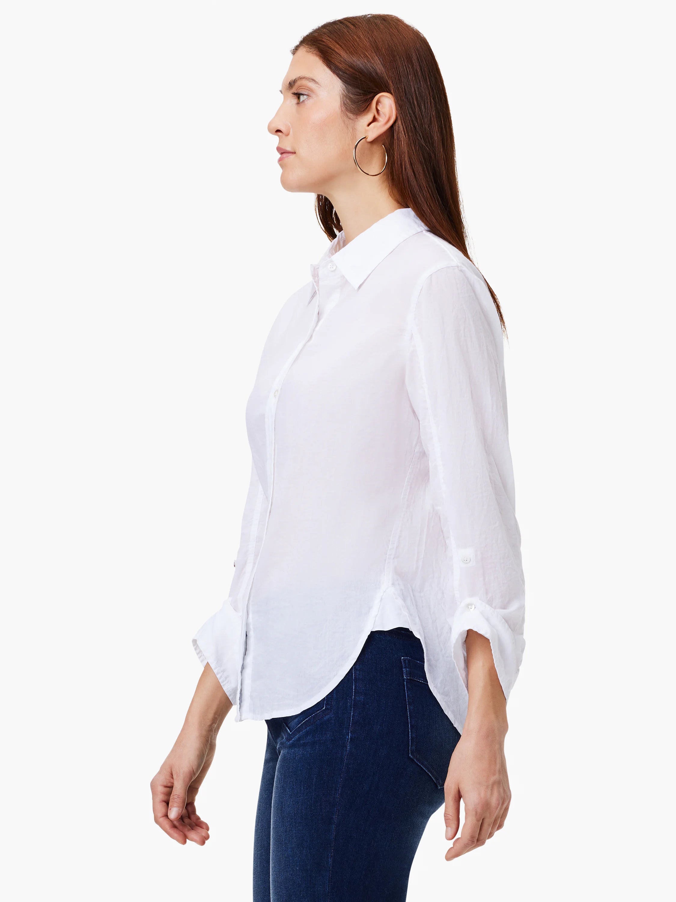White collared shirt with button front, long sleeves rolled up, and a rounded, untucked hem.
