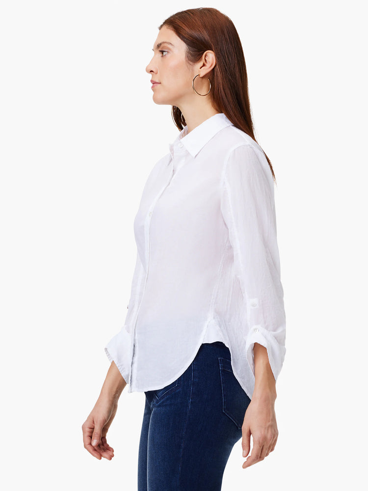 White collared shirt with button front, long sleeves rolled up, and a rounded, untucked hem.