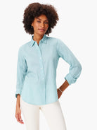 Aqua blue button-down shirt with a collar, white buttons, and sleeves rolled to the elbow.