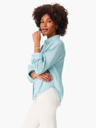 Aqua cotton button-down shirt with a relaxed fit, long sleeves rolled, and a slightly crinkled texture.