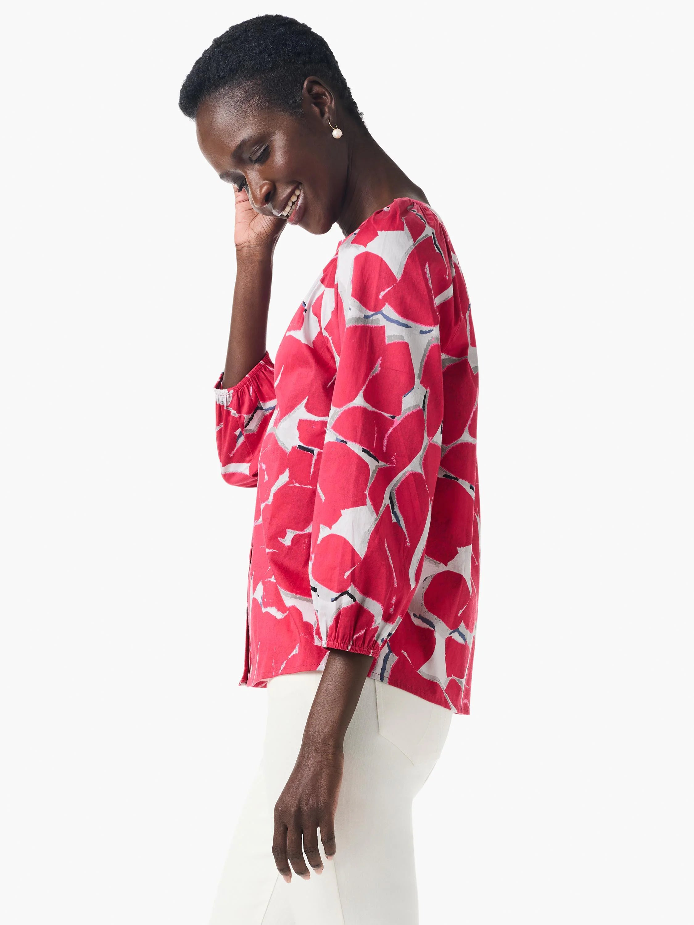 Pink shirt with an abstract, bold floral print in grey and white.  Three-quarter sleeves.