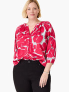 Pink button-front shirt with gray and white abstract print. Three-quarter sleeves.