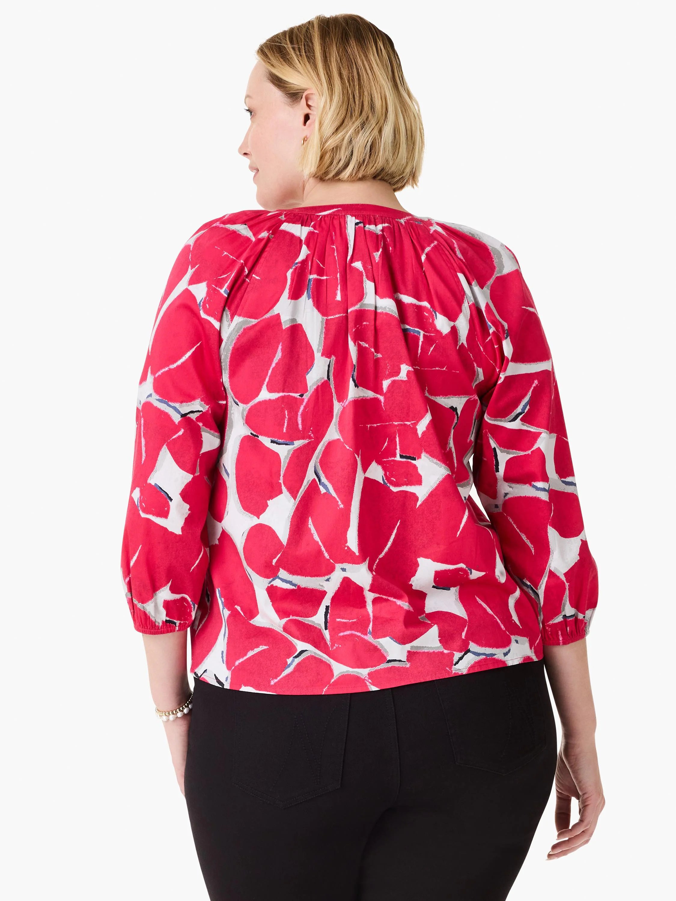 Back view of a pink shirt with an abstract, bold petal print in grey and white.  Three-quarter sleeves.