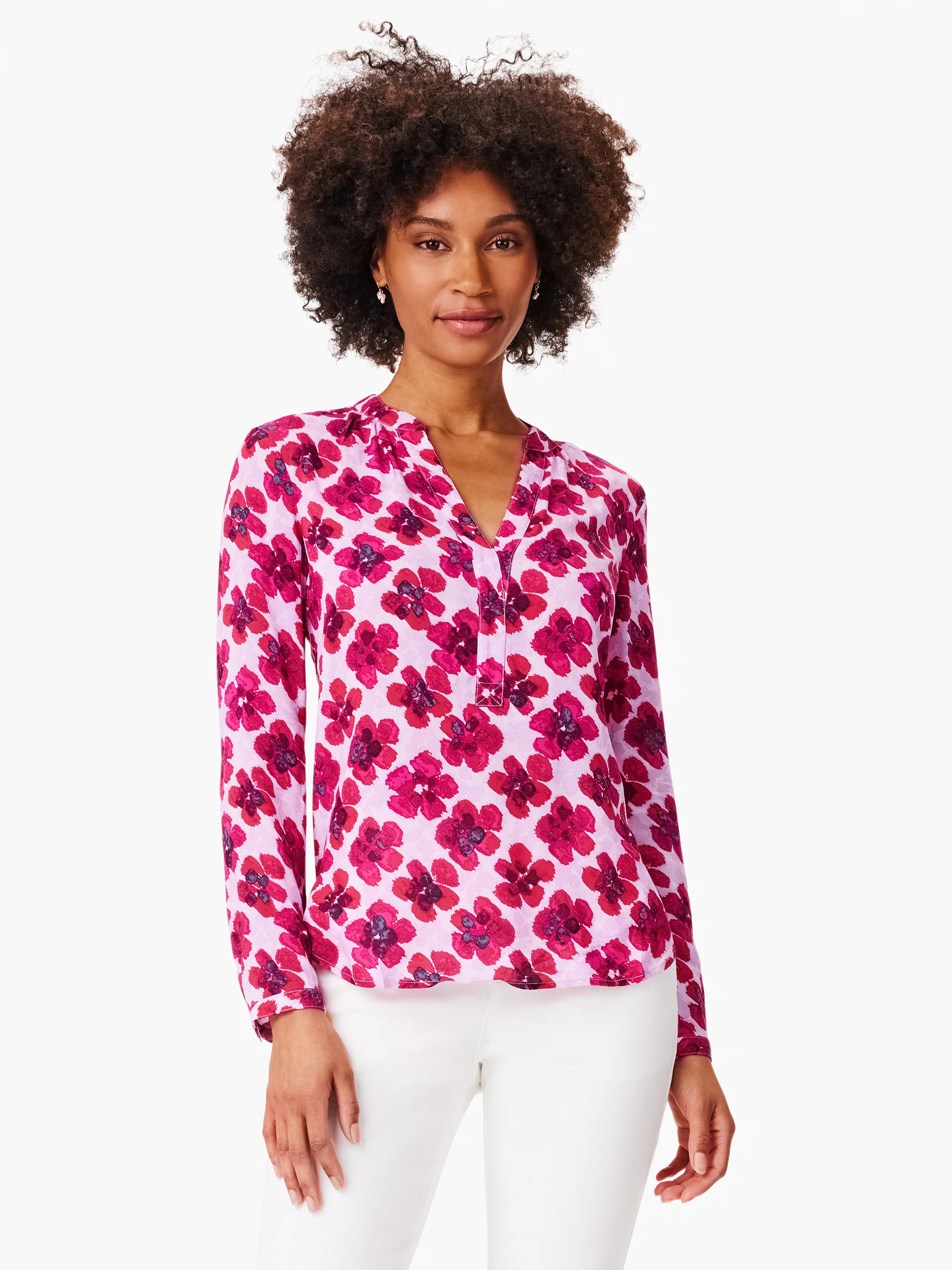 Pink long-sleeved blouse with a v-neck and a red floral print.