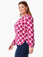 Pink long-sleeve blouse with a pink and fuchsia abstract floral print.  V-neck.