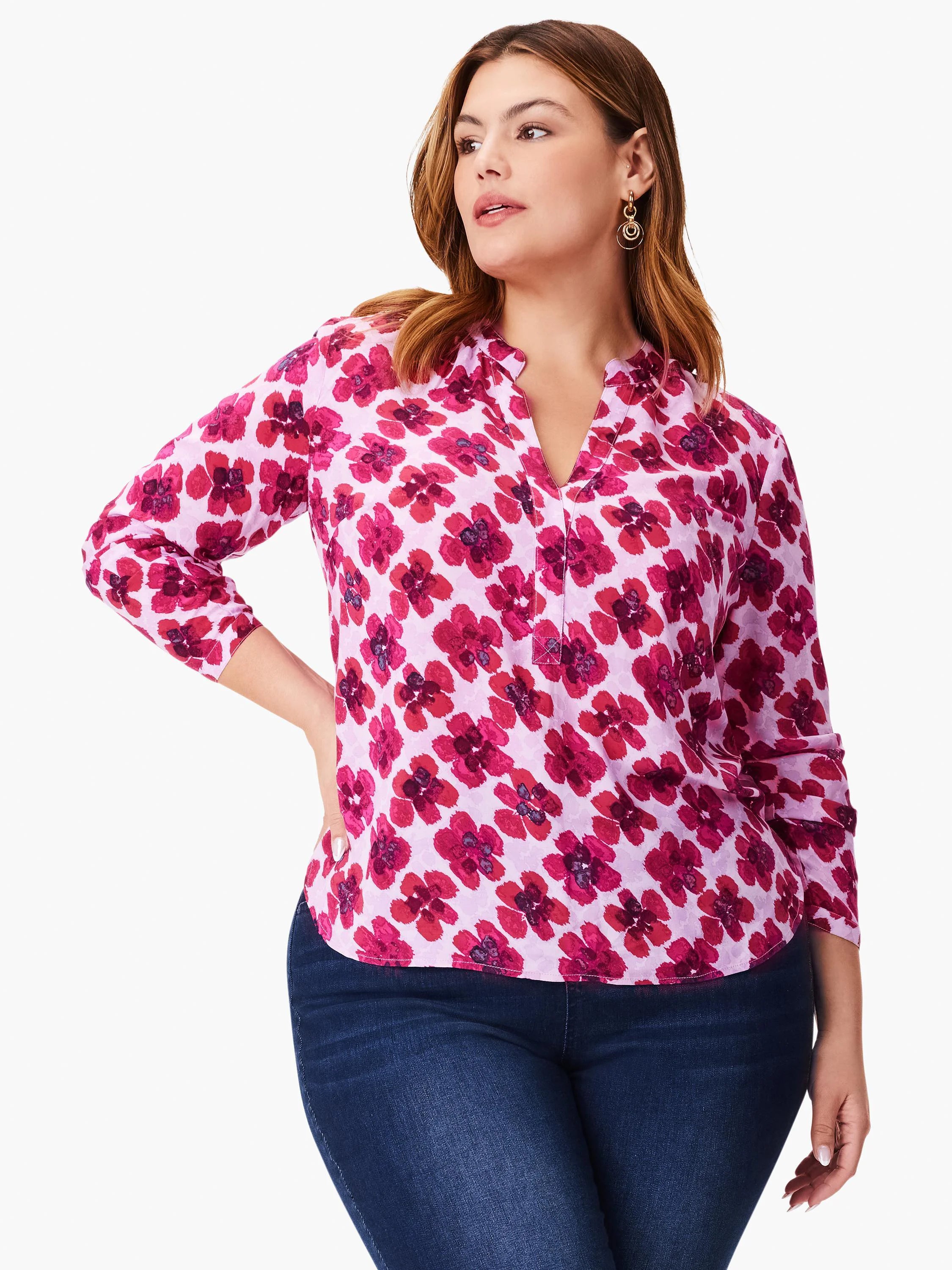 Pink top with a V-neck and three-quarter sleeves.  Features a pink and fuchsia abstract floral print.