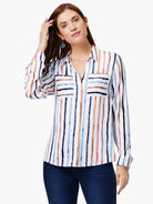 White long-sleeve top with vertical painted stripes in navy, sky blue, coral, and tan. Features collar & chest pockets.
