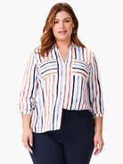 White V-neck collared top with vertical painted stripes in navy, blue, coral, and brown. Sleeves rolled to 3/4 length.