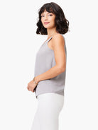 Light grey satin chiffon scoop neck tank top, sleeveless with a smooth drape, worn by a woman.