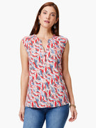 Sleeveless top, V-neck, off-white background with red, blue, and taupe abstract print.