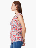 Sleeveless top, red, blue, and beige abstract print on a white background.  Cap sleeves and V-neck.