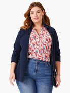 Navy blue zip-up jacket.  Features a collar and long sleeves.  Model also wears a cream, red, and blue patterned shirt...
