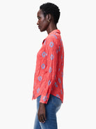 Red crinkled shirt with a blue pattern.  Long sleeves, collared.
