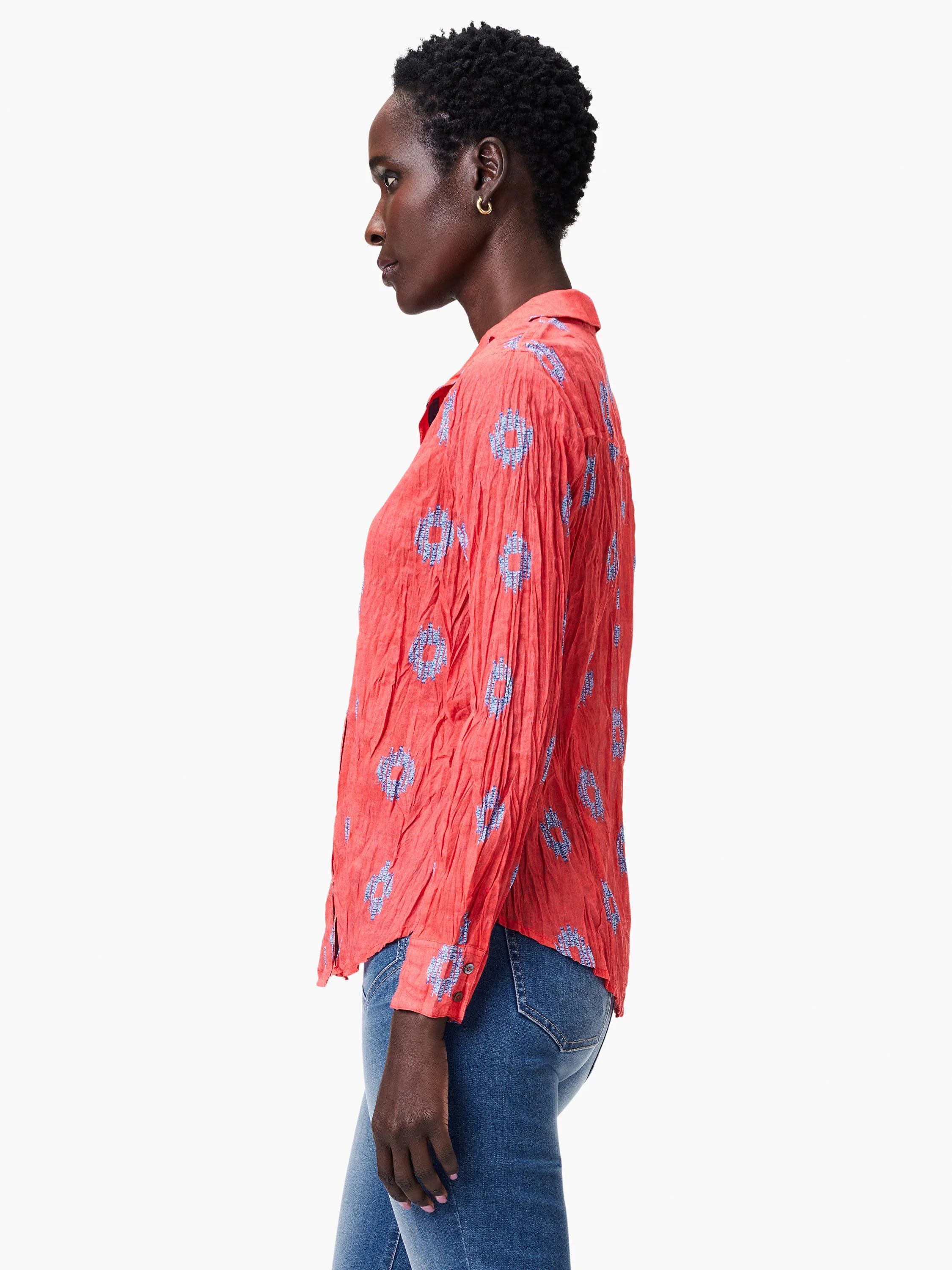 Red crinkled shirt with a blue pattern.  Long sleeves, collared.