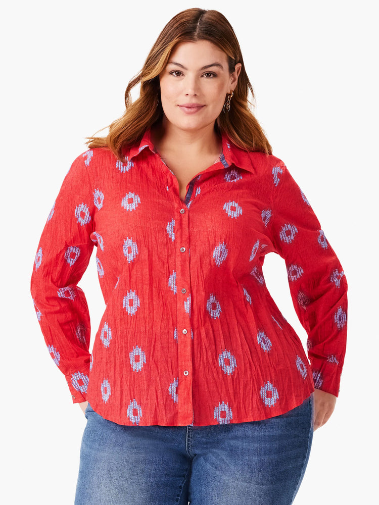 Red button-front shirt with a crinkled texture and small, light blue patterned design. Long sleeves.