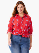 Red button-down shirt with a crinkled texture and a light blue geometric pattern.  Long sleeves.