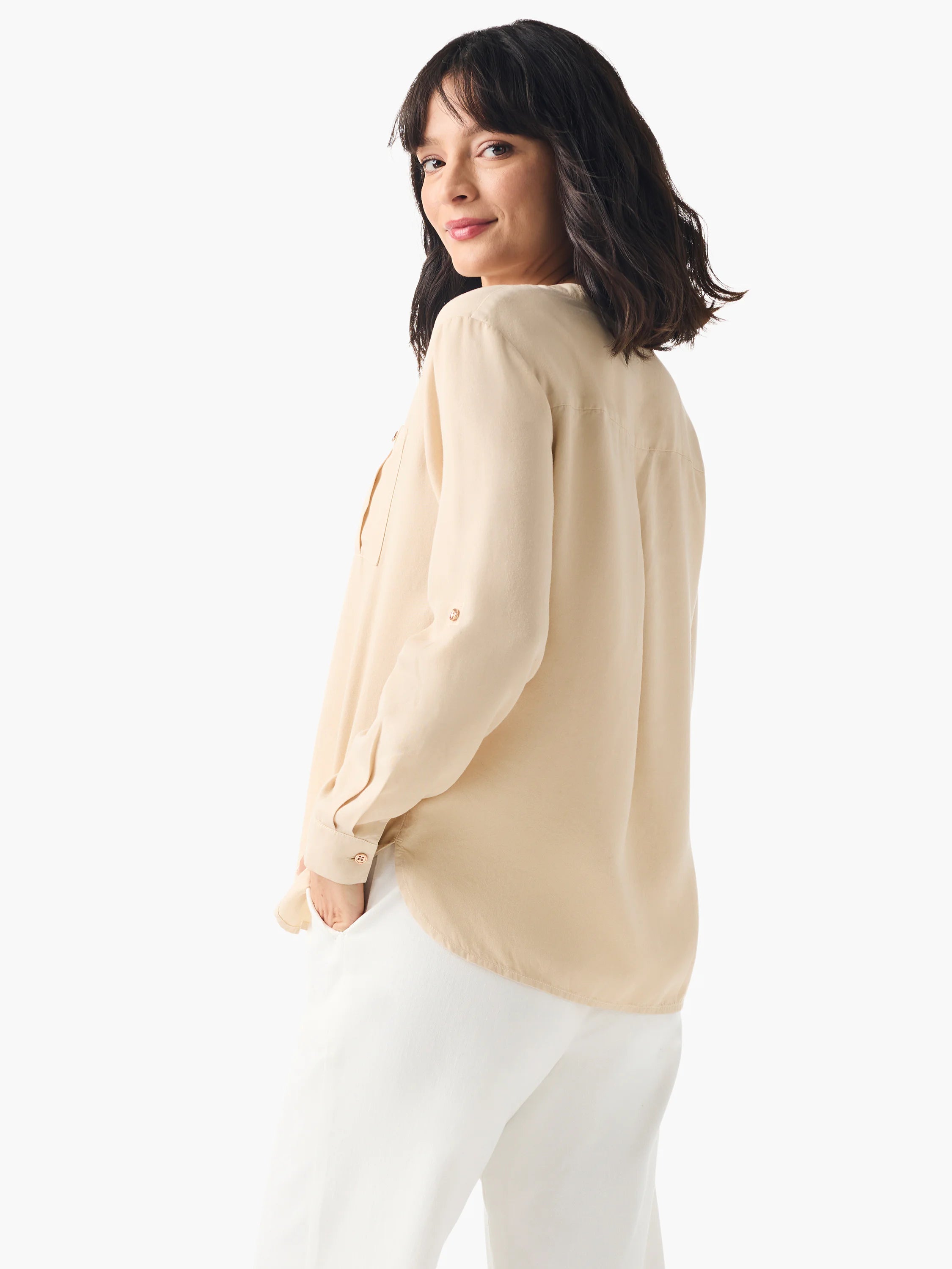Beige, long-sleeve shirt; collared, button-down; drapey fabric.  Model shown wearing with white pants.