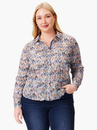 Crinkled, long-sleeved button-down shirt.  Tan, blue, and pink abstract print on a light background.