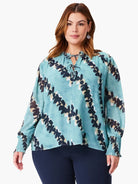 Teal long-sleeve blouse with a dark-blue and beige abstract print, keyhole neckline, and elasticized cuffs.