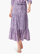 Lilac tiered midi skirt with a dark purple floral print.  A front slit is visible.