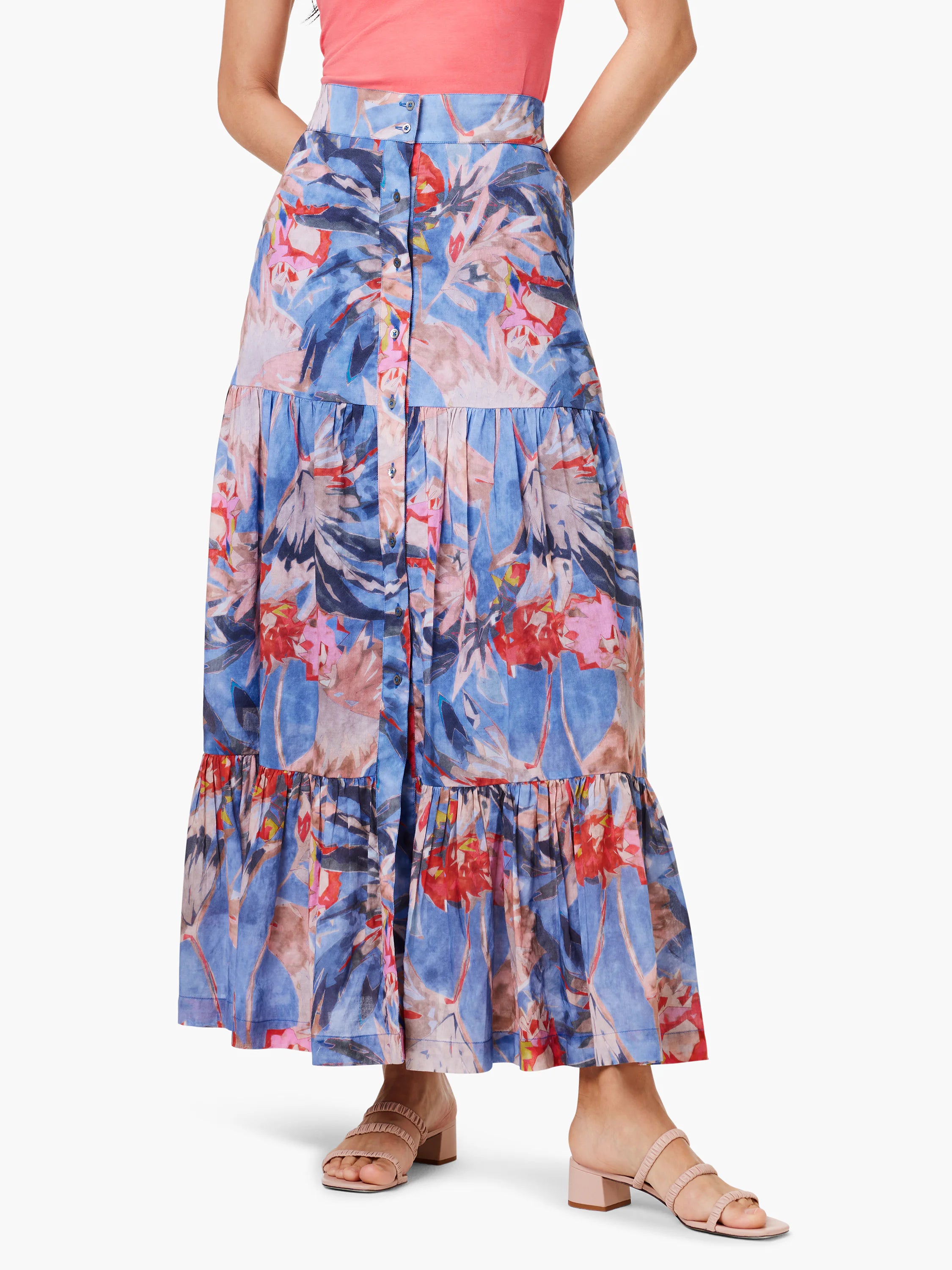 Tiered maxi skirt in blue, with red and pink abstract floral print. Button front.