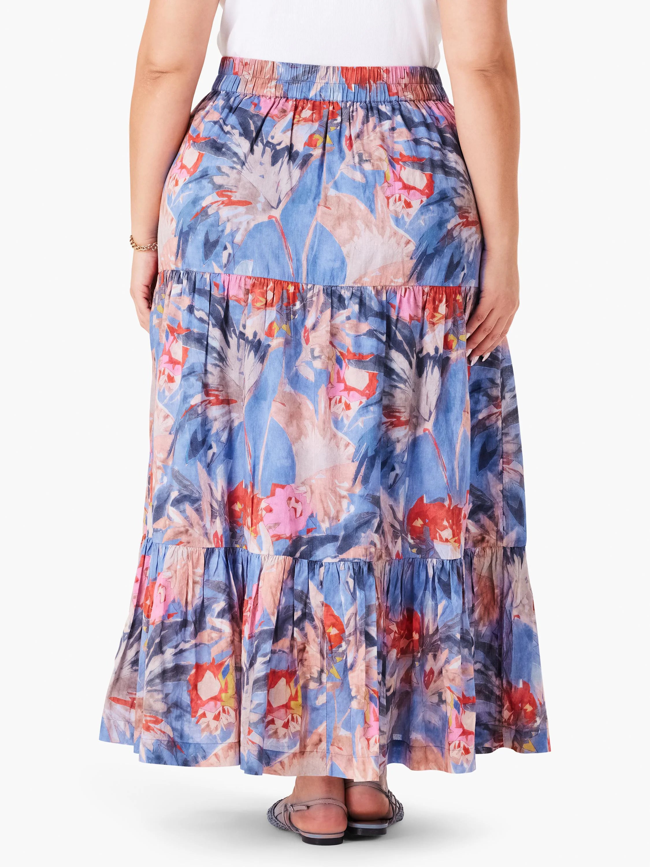 Tiered maxi skirt, blue base with red, pink, and gray abstract floral print. Elastic waistband.