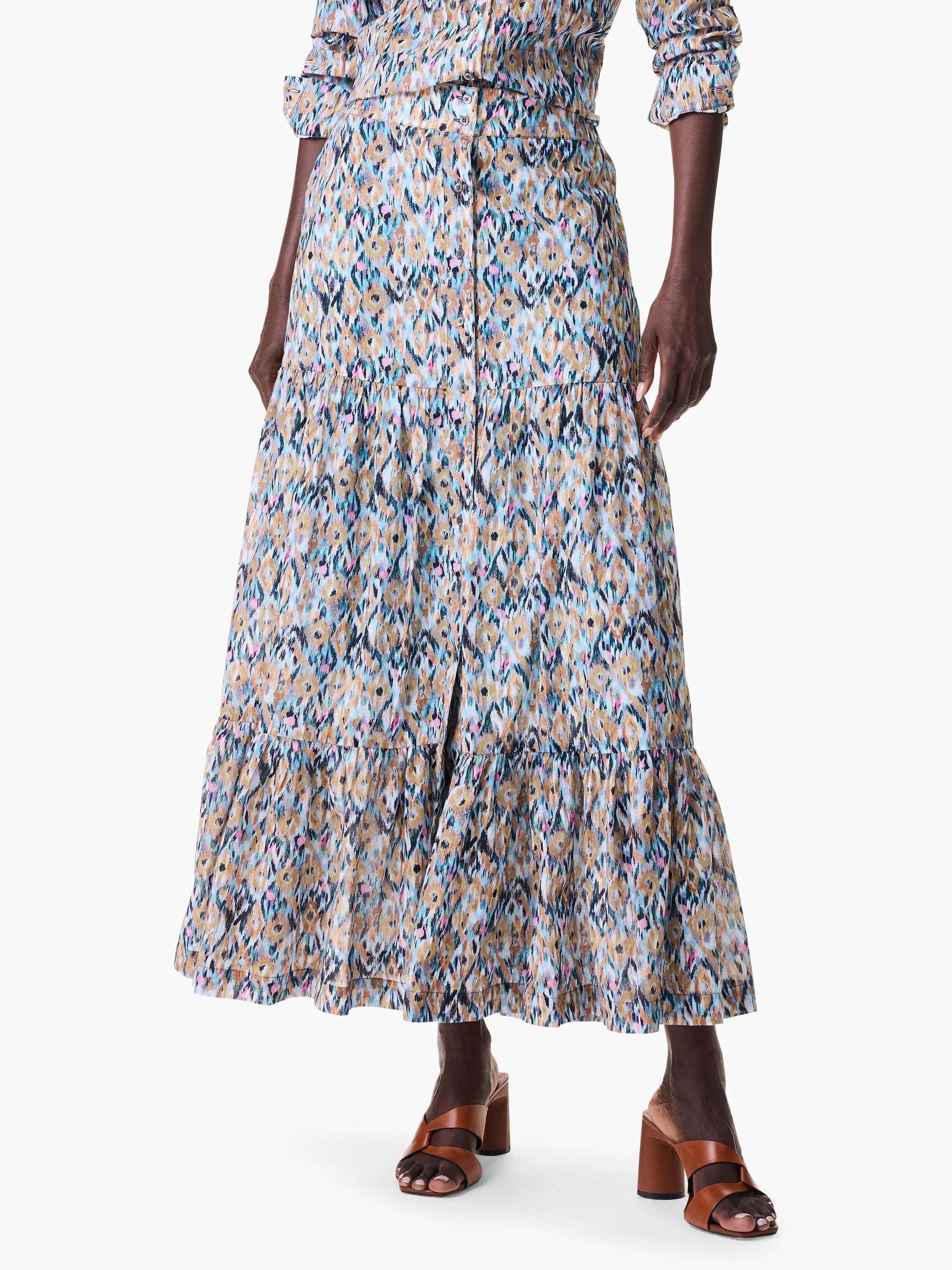 Maxi skirt with tiered ruffle hem.  Ikat-style print in teal, beige, pink, and black on a white background.