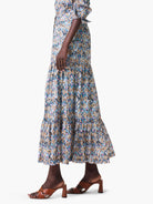 Maxi skirt with tiered ruffle hem. Ikat-style print in blue, beige, pink, and black.