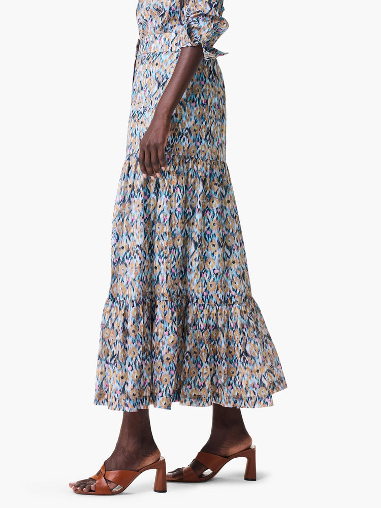 Maxi skirt with tiered ruffle hem. Ikat-style print in blue, beige, pink, and black.