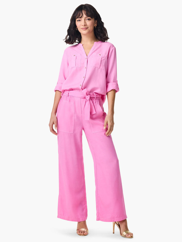 Bright pink drapey wide-leg utility pants with large front patch pockets and a matching tie-belt.