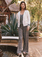 Wide-leg pants with vertical black and beige stripes on a model.