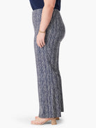 Wide-leg pants; navy blue with off-white vertical stripes.  A model is wearing them.