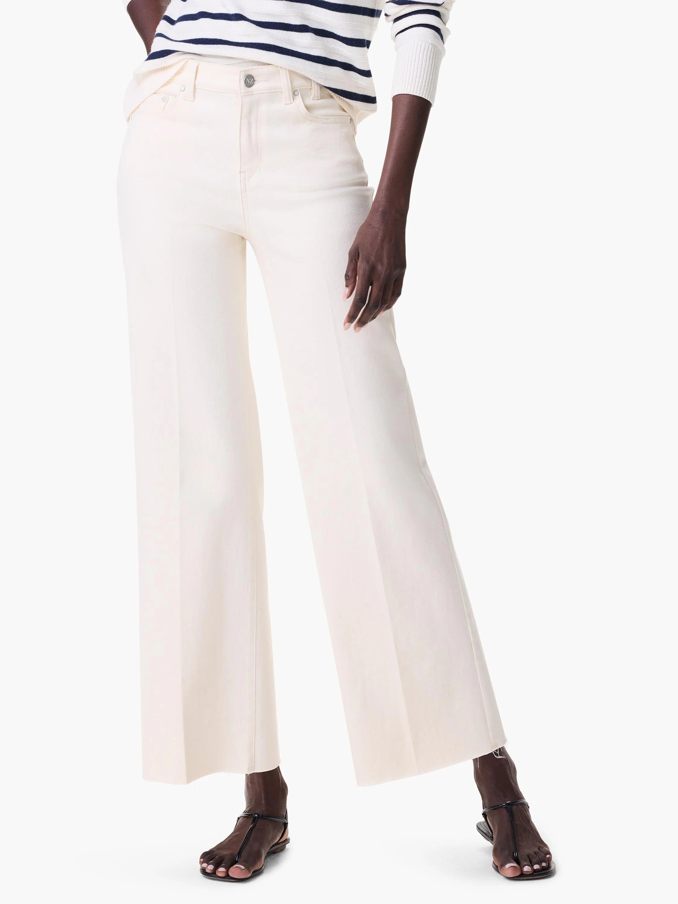 Cream wide leg jeans. Features a high waist, front pockets, and a frayed hem.
