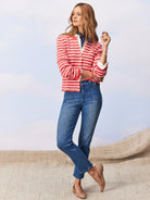 Medium blue mid-rise straight jeans with distinct rectangular front patch pockets and a cropped ankle length.