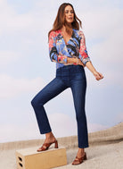 Dark wash, mid-rise straight jeans with prominent front patch pockets and a slightly cropped ankle length.