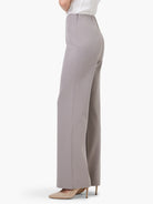Light gray wide-leg trousers, high-waisted, with a concealed side zipper, shown on a model from the side.
