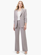 Light grey-taupe wide-leg trousers, styled with a matching blazer on a woman.