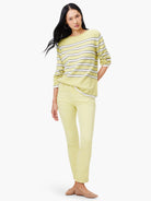 Pale yellow mid-rise straight jeans featuring visible front patch pockets.